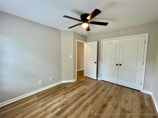 a view of empty room with wooden floor