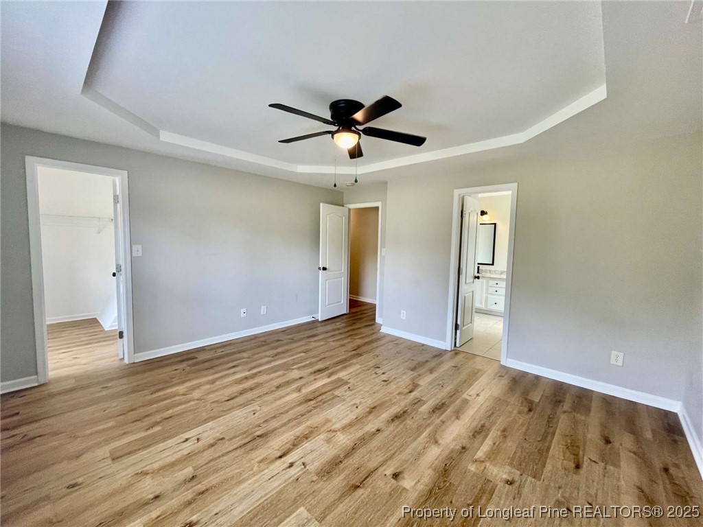 216 Cobblestone Drive Spring Lake, NC 28390 - Photo 9 of 30 a view of empty room with wooden floor and ceiling fan
