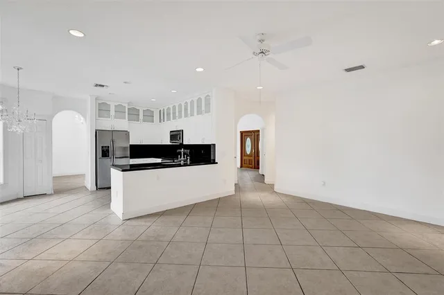 an empty room with white walls and tiles
