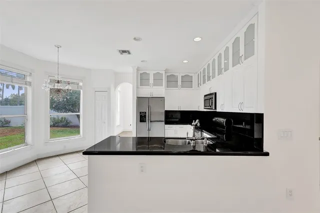 a bathroom with a sink vanity mirror and toilet