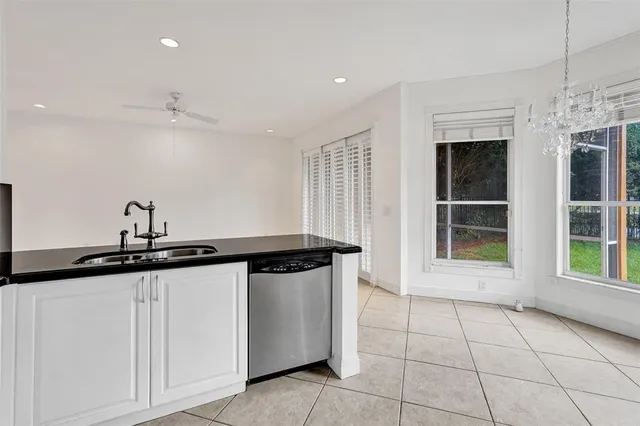 a view of an empty room with wooden floor and windows