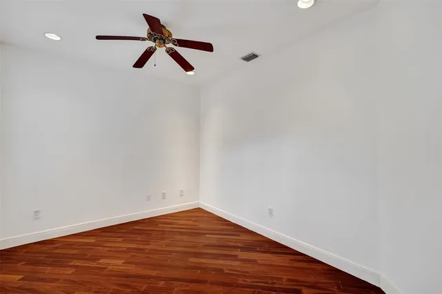 a view of an empty room with glass door and a window