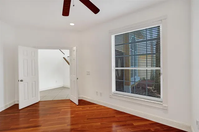 a view of an empty room with wooden floor