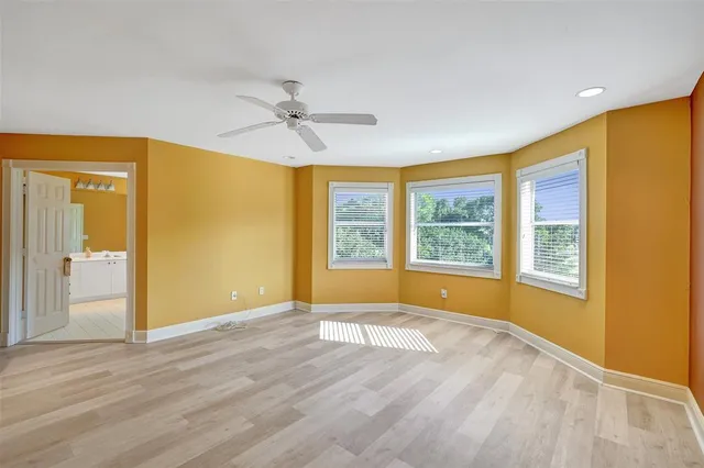a bathroom with a bathtub a sink and a window