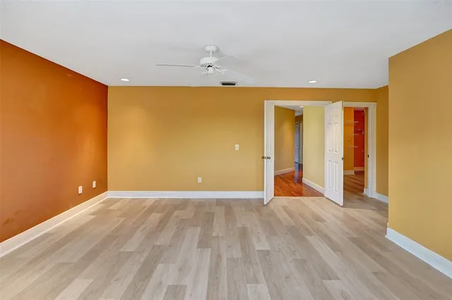 a view of a room with wooden floor and door