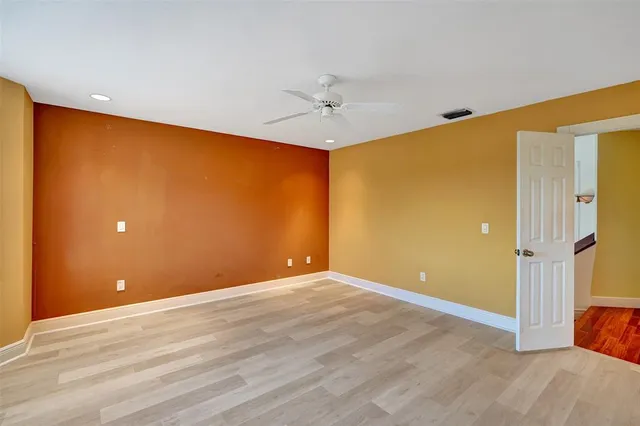 a bathroom with a light fixture and a glass door