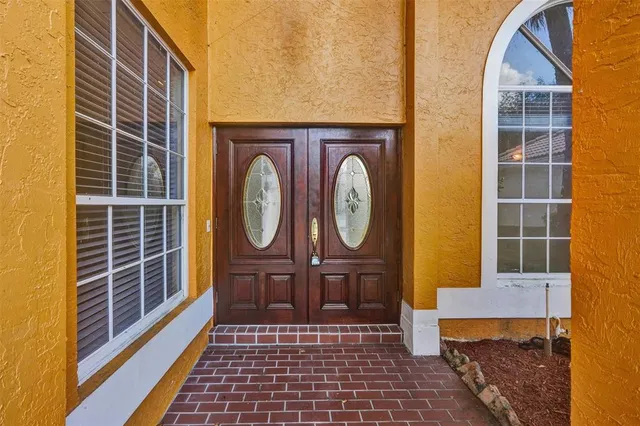 a view of a room with a chandelier and windows