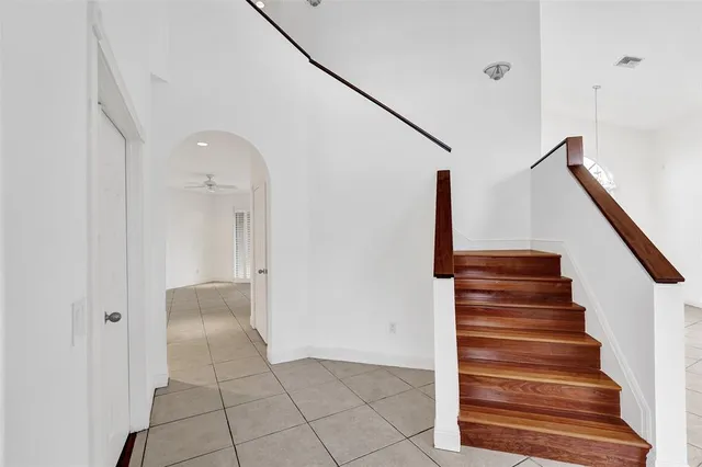 a kitchen with stainless steel appliances kitchen island granite countertop a refrigerator and a stove top oven