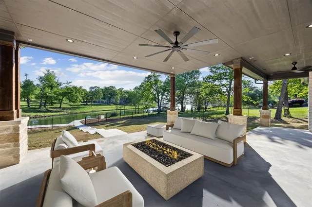 a view of a patio with couches and pool
