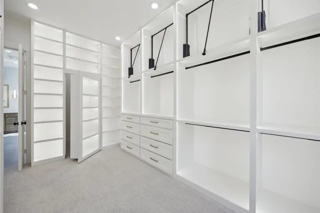 a view of walk in closet with empty racks
