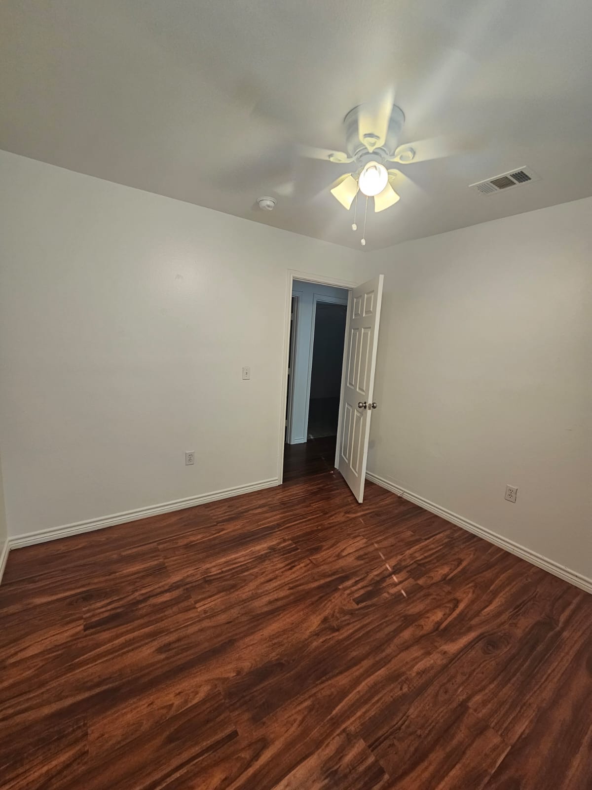 606 Trinity Street Lockhart, TX 78644 - Photo 14 of 23 Rich hardwood-style flooring creates a warm and inviting atmosphere.