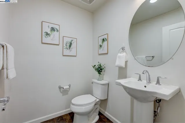 a bathroom with a sink toilet and a mirror