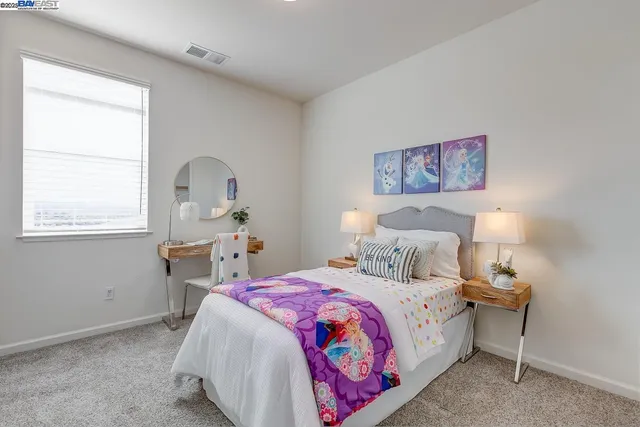 a bedroom with a bed and a table in it