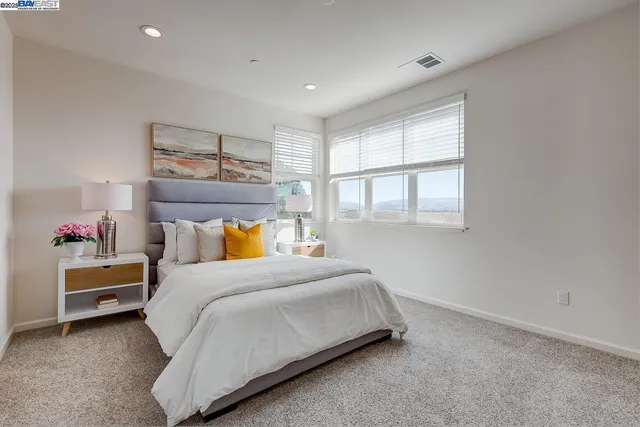 a bedroom with a bed and a window