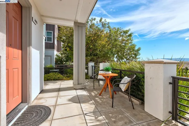 a patio with glass windows and table