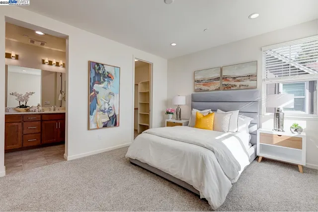 a bedroom with a bed and a view of kitchen