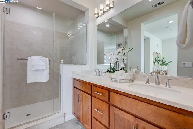 a bathroom with double vanity sink and a mirror