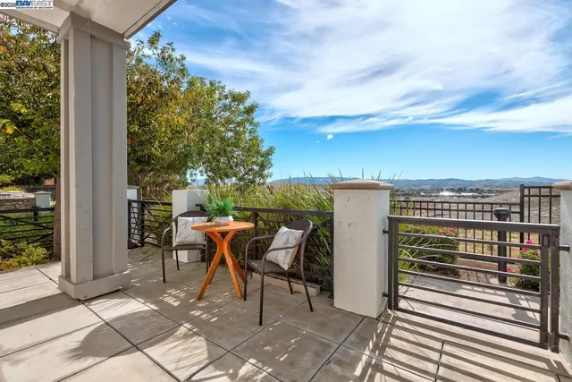 a balcony with table and chairs