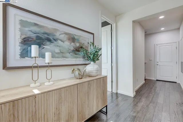 a kitchen with stainless steel appliances a counter top space and a wooden floor