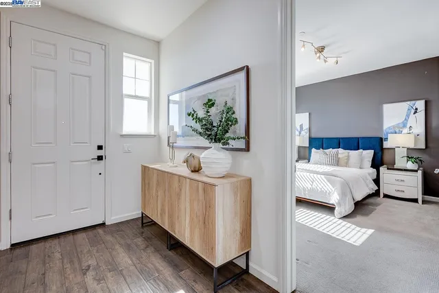 a bedroom with furniture and wooden floor