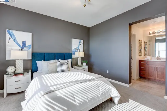 a bedroom with a bed and a lamp