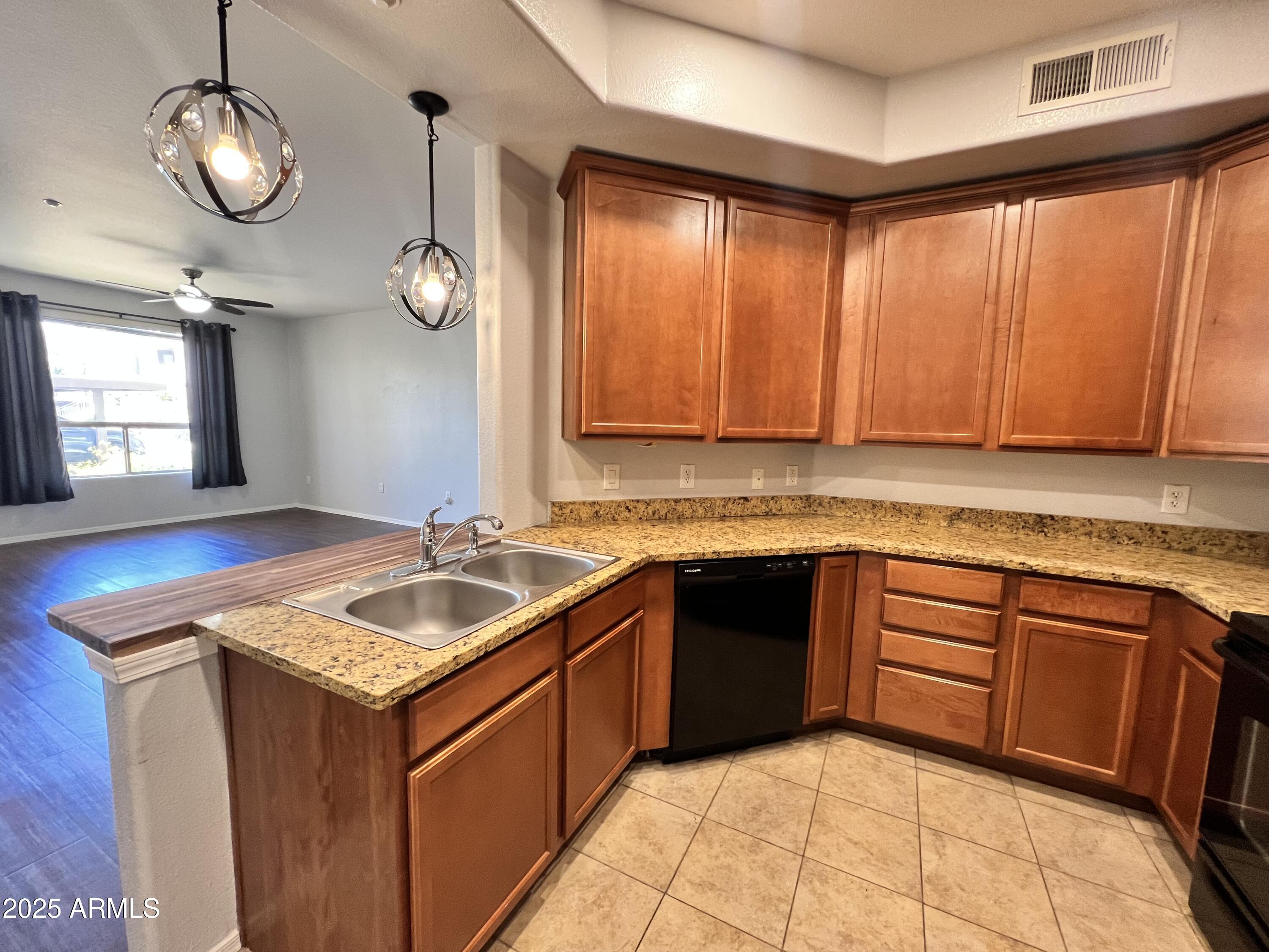 5303 North 7th Street, Unit 132 Phoenix, AZ 85014 - Photo 11 of 32 a kitchen with a sink stove and cabinets