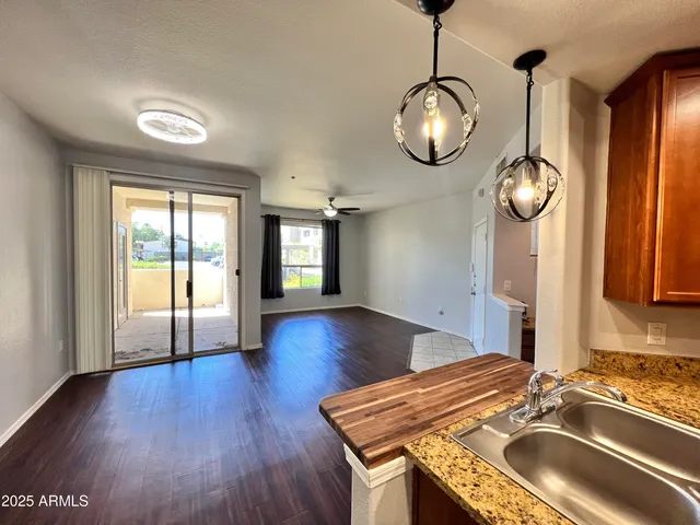 a very nice looking room with wooden floor and large window