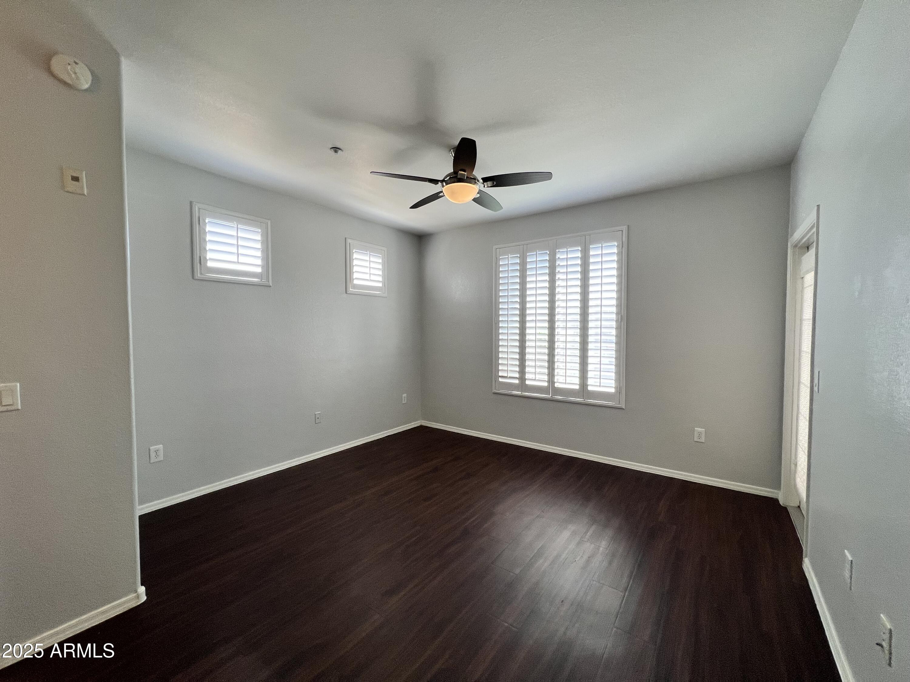 5303 North 7th Street, Unit 132 Phoenix, AZ 85014 - Photo 21 of 32 a view of an empty room with wooden floor and a window