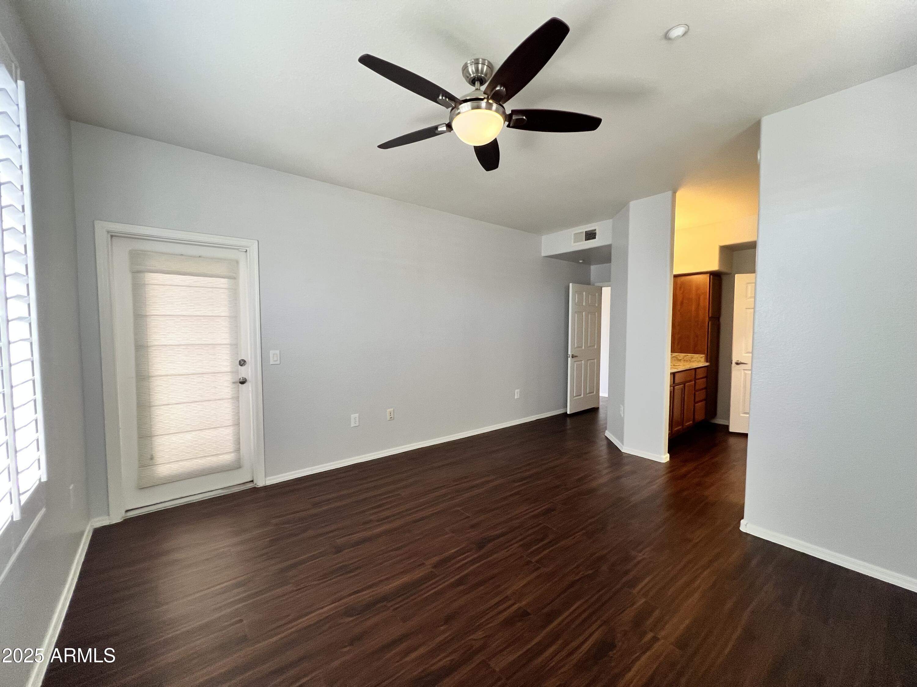5303 North 7th Street, Unit 132 Phoenix, AZ 85014 - Photo 22 of 32 an empty room with wooden floor and windows