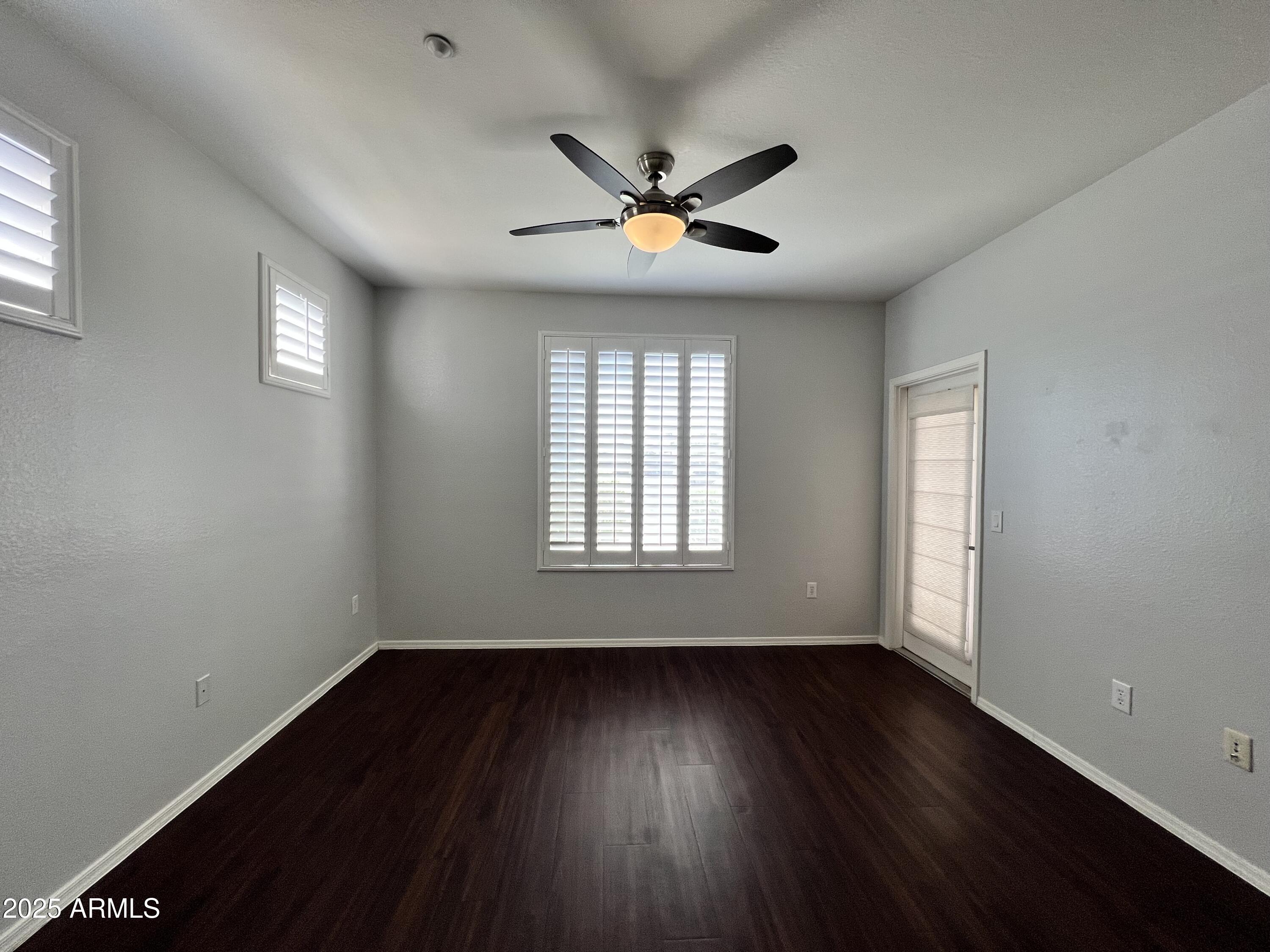 5303 North 7th Street, Unit 132 Phoenix, AZ 85014 - Photo 23 of 32 a view of an empty room with wooden floor and a window