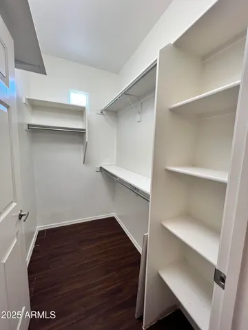 a view of walk in closet with empty racks
