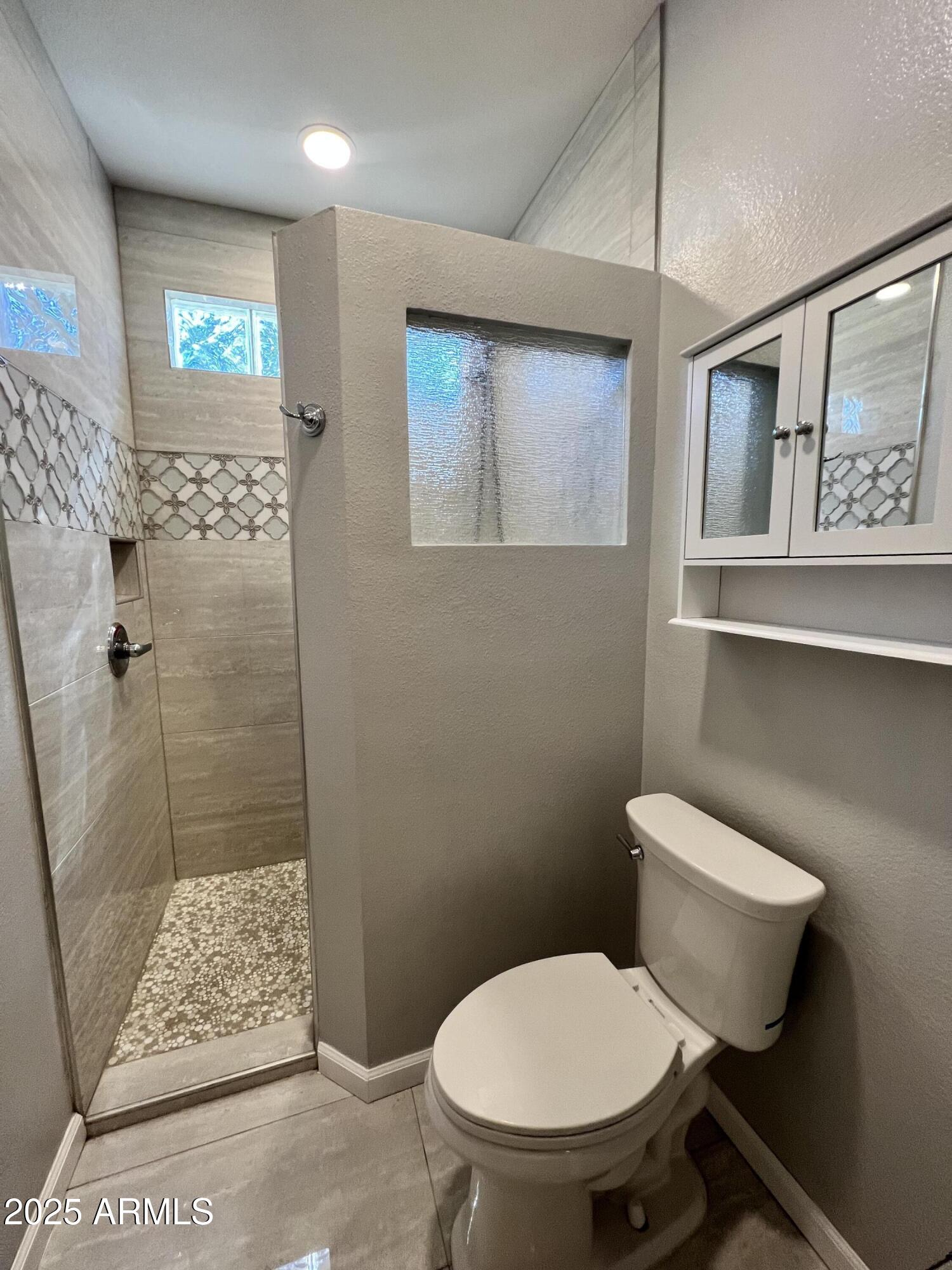 5303 North 7th Street, Unit 132 Phoenix, AZ 85014 - Photo 25 of 32 a bathroom with a toilet and a shower