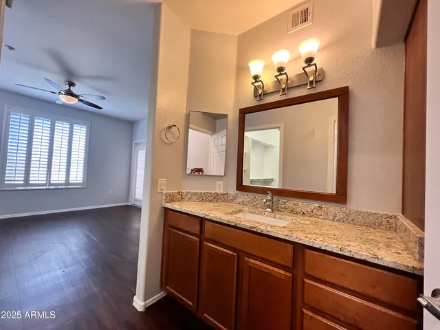a bathroom with a sink vanity and a mirror