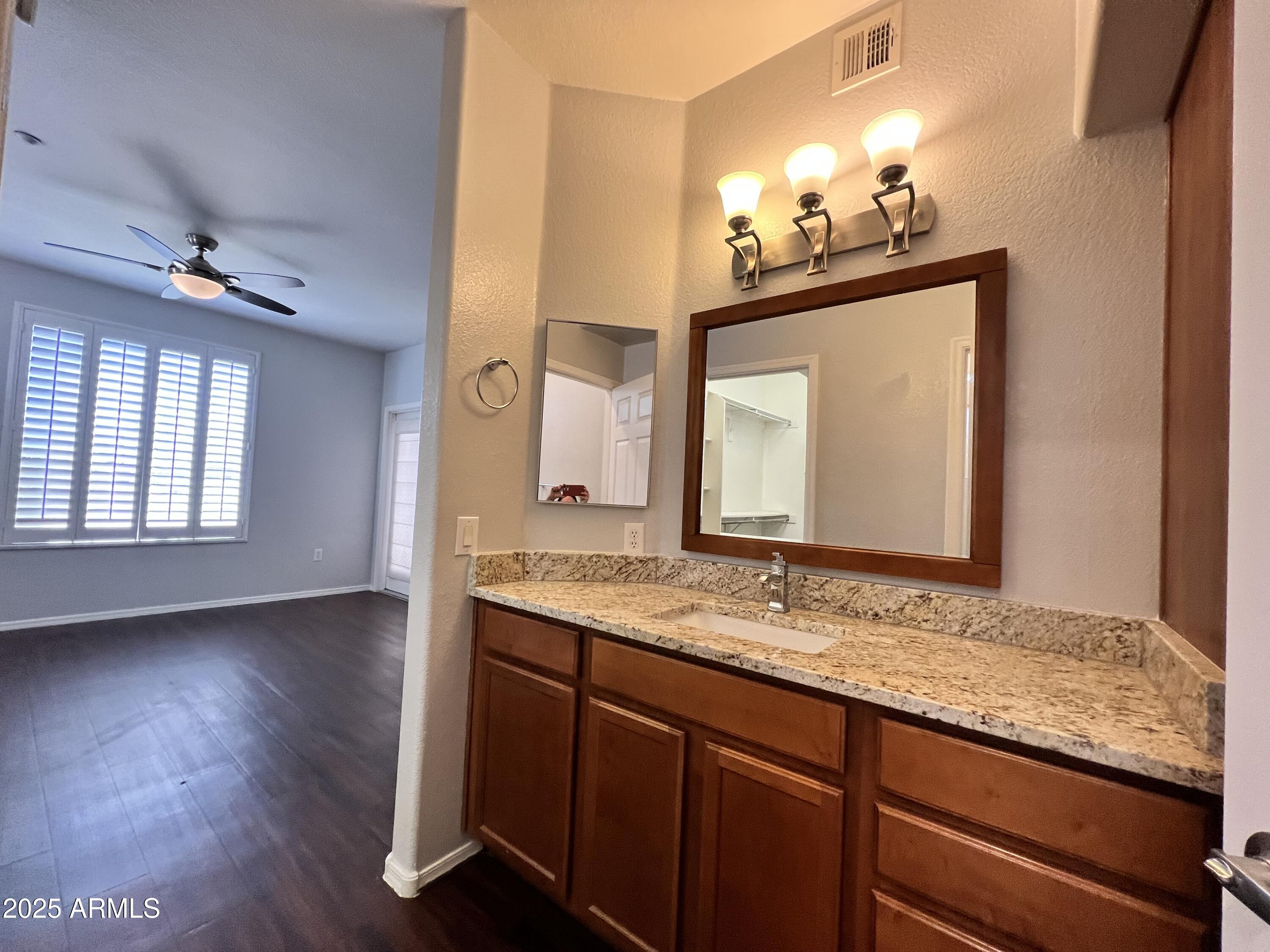5303 North 7th Street, Unit 132 Phoenix, AZ 85014 - Photo 27 of 32 a bathroom with a sink vanity and a mirror