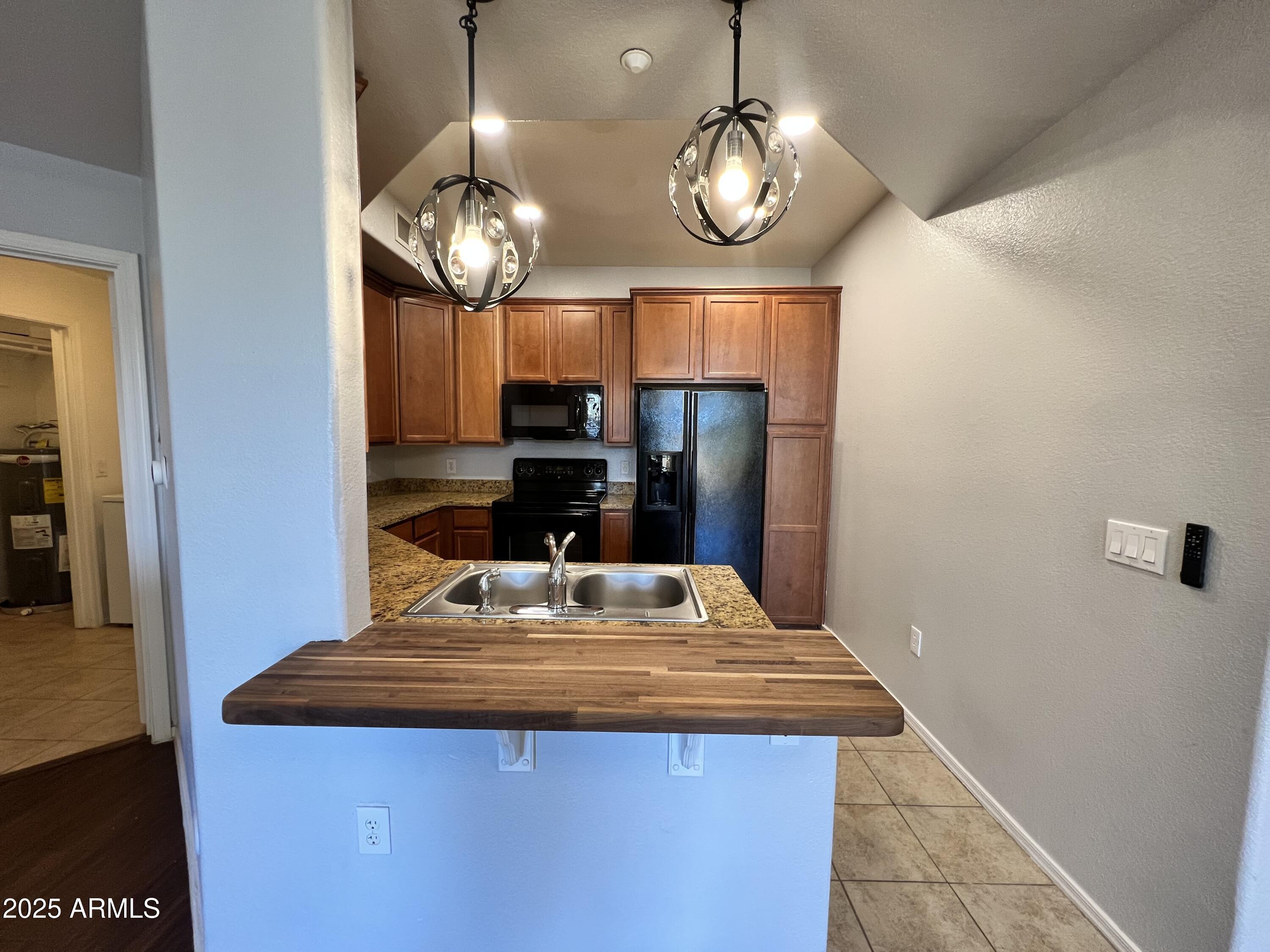 5303 North 7th Street, Unit 132 Phoenix, AZ 85014 - Photo 9 of 32 a view of a dining room with a table chairs and chandelier
