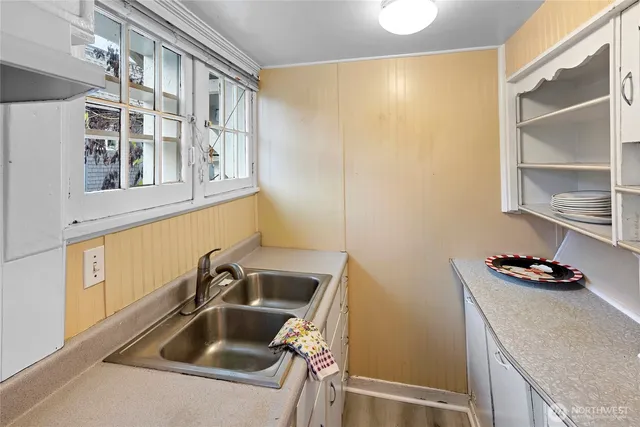 a kitchen with a sink and a refrigerator