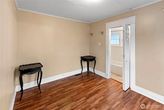 a view of a livingroom with wooden floor and a window