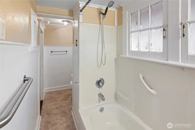a bathroom with a bathtub and a shower