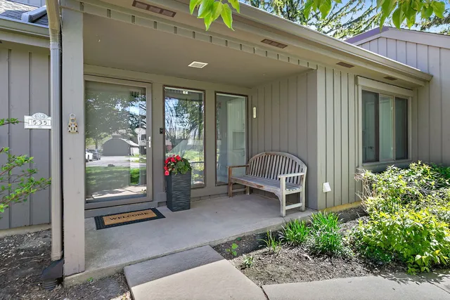 a view of a porch with furniture and floor to ceiling window