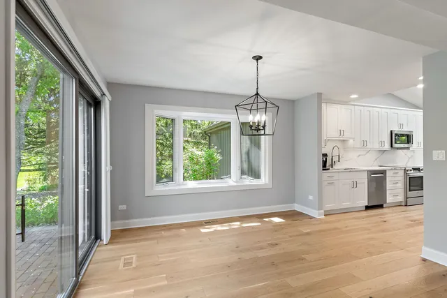 a view of a kitchen with microwave and windows