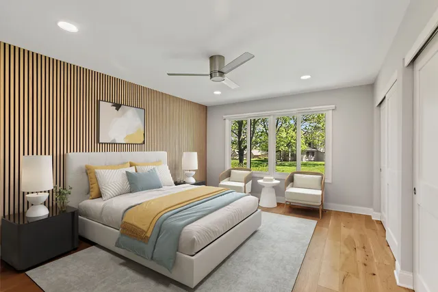 a bedroom with a large bed couch and a window