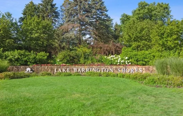 a view of a lake with lawn chairs