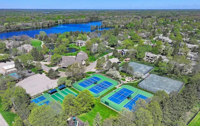 an aerial view of a house with a yard and outdoor seating