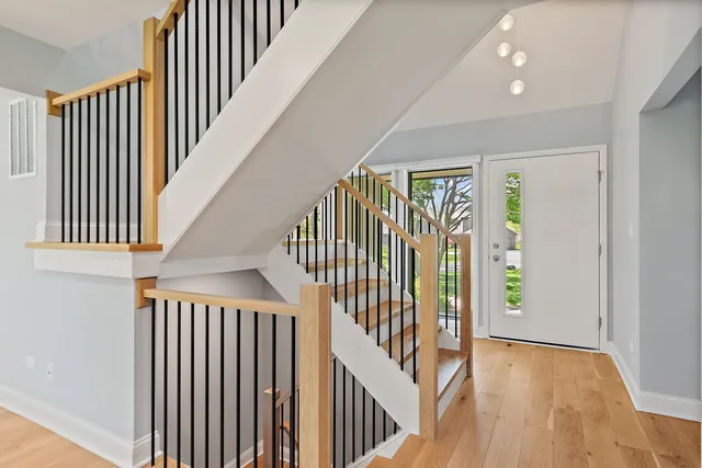 a view of a hallway with wooden floor and entryway