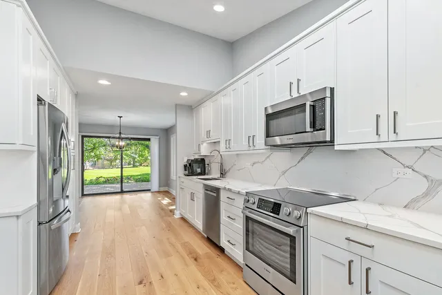 a kitchen with a stove a sink and a microwave