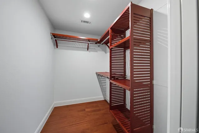 a view of hallway with stairs and wooden floor