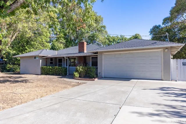 a front view of a house with a yard and a garage