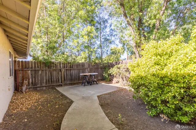 a view of outdoor space with wooden fence and trees