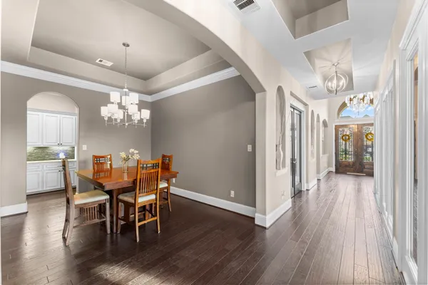 a view of a dining room with furniture and wooden floor