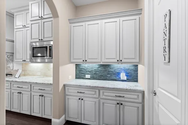 a kitchen with stainless steel appliances granite countertop white cabinets and sink